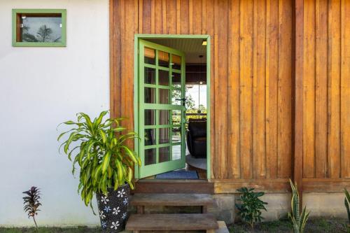 an open door to a house with a potted plant at Casa Carabinani in Novo Airão