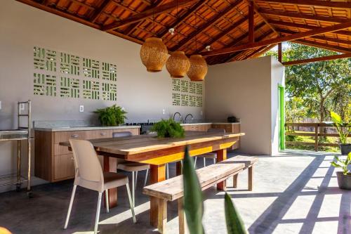 a kitchen with a wooden table and chairs at Casa Carabinani in Novo Airão