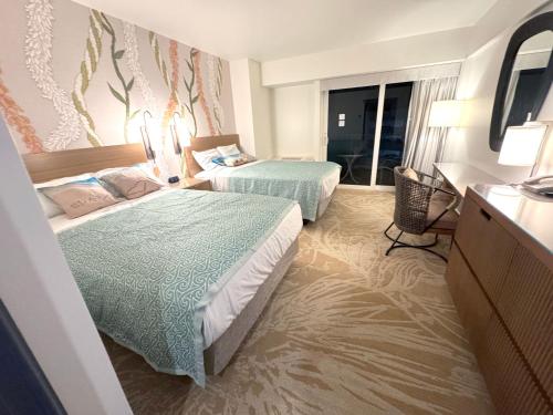 a hotel room with two beds and a window at ~Four-star serviced apartment in Honolulu