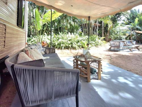 a living room with a couch and a table at Vintage Coral Pink in Nelly Bay