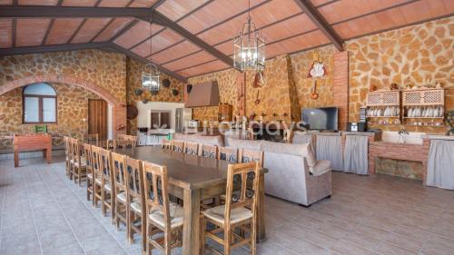 a dining room with a table and a couch at Casa Rural Lucena in Lucena
