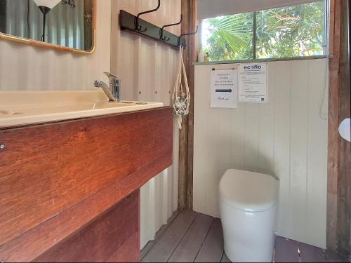 a bathroom with a sink and a toilet at Vintage Coral Pink in Nelly Bay