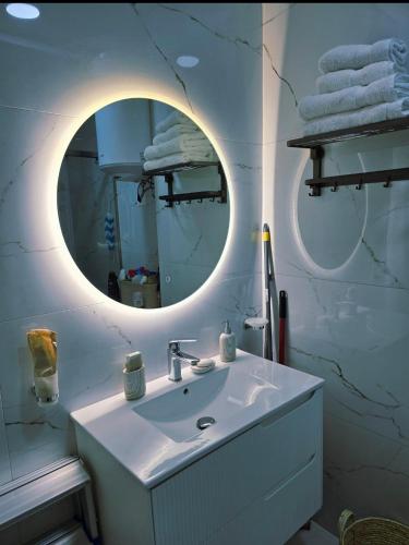 a bathroom with a sink and a mirror at 60 seconds walk to the Beach in Golem