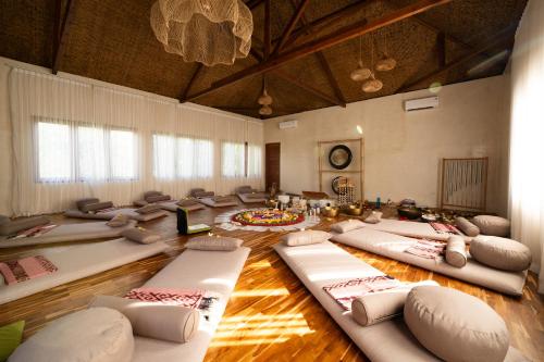 a large room with many pillows on the floor at Divino Gili Air in Gili Air