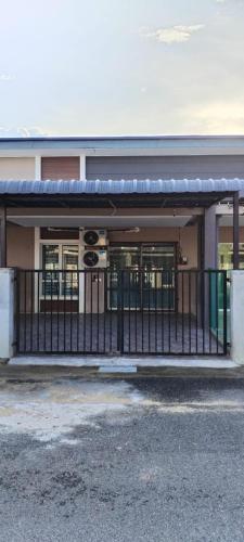 a building with a fence in front of it at Sobey Laris Homestay PASIR MAS in Pasir Mas