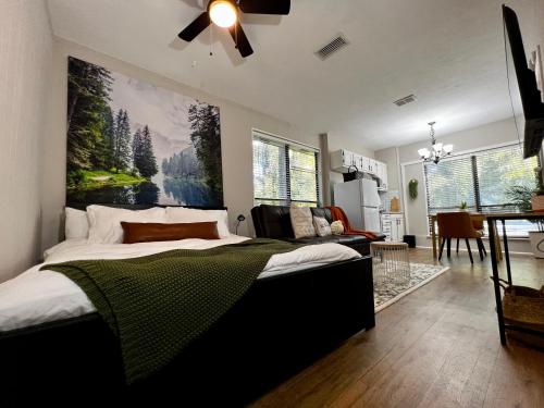 a bedroom with a bed with a large painting on the wall at Guest Studio in Gainesville