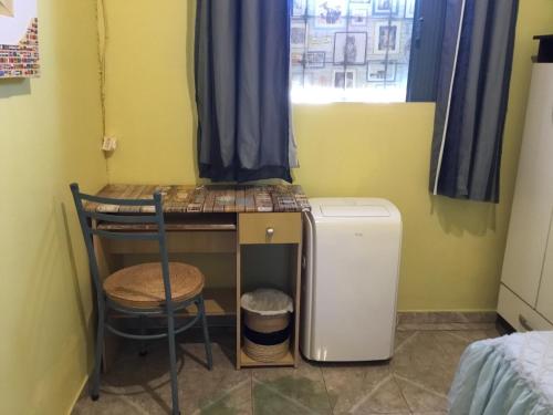a room with a table and a small refrigerator at Casa Refúgio Cataratas by Grasi in Foz do Iguaçu