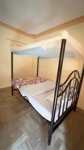 a bed in a room with a bunk bed at Highland hotel kapchorwa in Kapchorwa