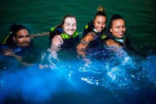 a group of four people in the water at Renacer ancestral Barú in Playa Blanca