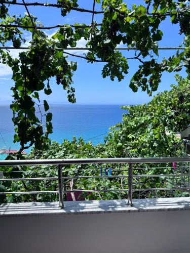 a view of the ocean from a balcony at Sevilia Rooms in Qeparo
