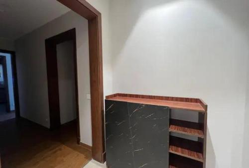 a room with a book shelf and a hallway at Randooo hoo in Kafr El-Shaikh