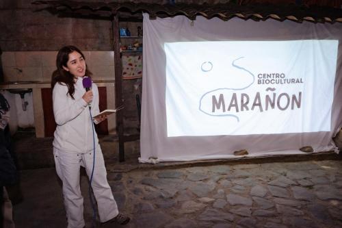 a woman giving a speech in front of a banner at Killa Wasi Chachapoyas in Chachapoyas