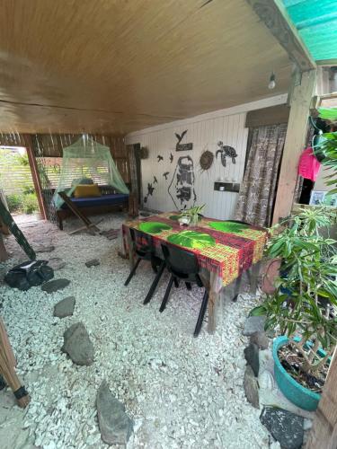 a room with a table and a tent in it at FARE Tatahi in Parea