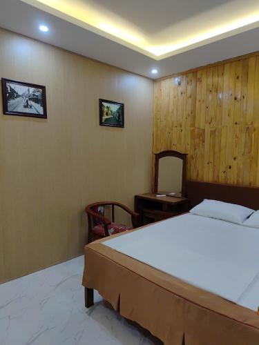 a bedroom with a bed and a wooden wall at Respect Homestay Phu Quoc in Phu Quoc