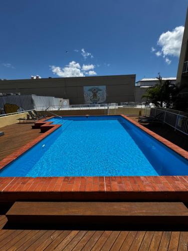 a large swimming pool on top of a building at In Cairns Hotel ,Hidden Gem in Cairns