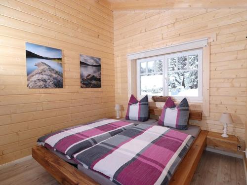 a bedroom with a bed in a wooden room at Holiday apartment with 2 bedrooms in Clausthal-Zellerfeld