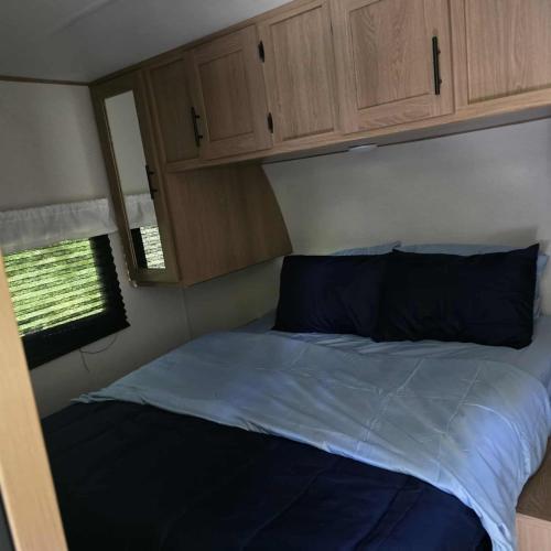a bedroom with a bed in an rv at Monday creek camper in New Straitsville