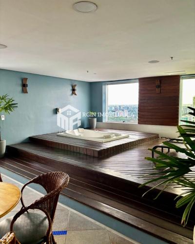 a room with a bed and a large window at Flat Premium Manaus no bairro Adrianópolis ao lado do shopping manauara in Manaus
