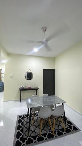 a dining room with a glass table and chairs at ABG JEFF HOMESTAYs in Bukit Payong