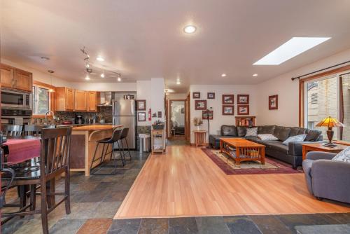 a kitchen and living room with a couch and a table at Lakeside Serenity Retreat in Kings Beach