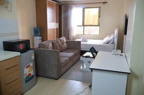 a small living room with a couch and a table at Maya City View Studios in Nairobi