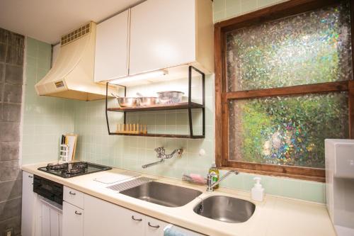 a kitchen with a sink and a window at 香琉 Kaoru in Miyako Island