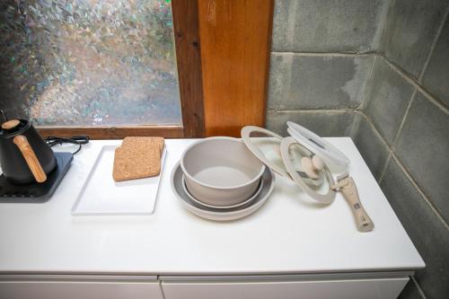 a white counter top with a bowl and a cup and a whisk at 香琉 Kaoru in Miyako Island