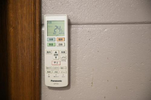 a remote control is hanging on a wall at 香琉 Kaoru in Miyako Island