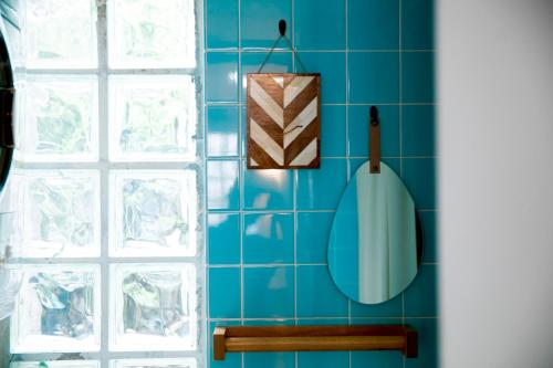 a blue tiled wall in a bathroom with a urinal at 香琉 Kaoru in Miyako Island