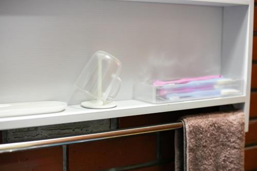 a shelf in a bathroom with some items on it at 香琉 Kaoru in Miyako Island