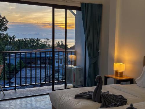 a bedroom with a balcony with a swan on a bed at Buddha View Hostel & Diving in Ko Tao