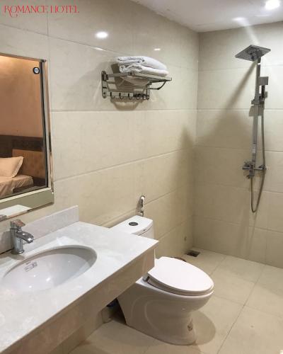 a bathroom with a toilet and a sink at Romance hotel in Cat Ba