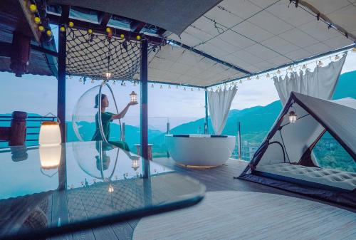 a woman is in a bubble in a tent at Longji One Art Hotel in Longsheng