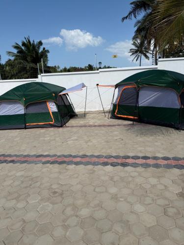 two tents are parked in a parking lot at MASAI Apartment Goba in Dar es Salaam