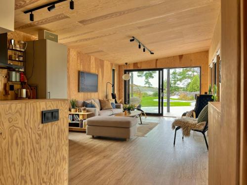 una sala de estar con un sofá y una mesa en Architect-Designed House Near Sea On Resö, en Resö