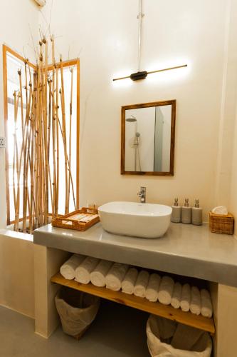 a bathroom with a sink and a mirror at WoCAL Resort Ke Ga in Xóm Chum Găng