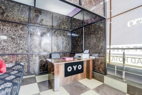an office with a desk with an ovo sign on the wall at Hotel O Happy Inn in Raipur
