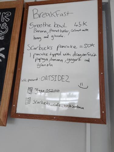 a white board with some writing on it at Scar Reef Homestay in Jereweh