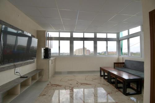 a living room with a couch and a table at HomeSlice Manor, Premium Apartment in Whitefield in Bengaluru