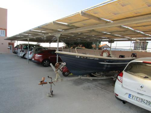 a boat is parked under a cover in a parking lot at Platsa Studios in Megás Limniónas