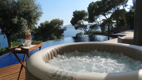 a bath tub with water in it on a deck at Blueview Villa in Llafranc