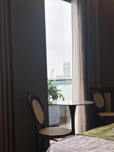 a room with a table and chairs and a window at MD Hotel in Mỹ Lộc