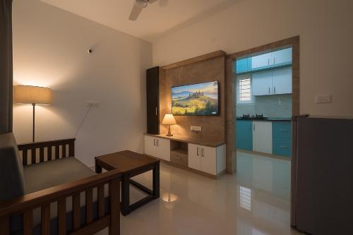 a living room with a couch and a table at HomeSlice Manor, Premium Apartment in Whitefield in Bengaluru