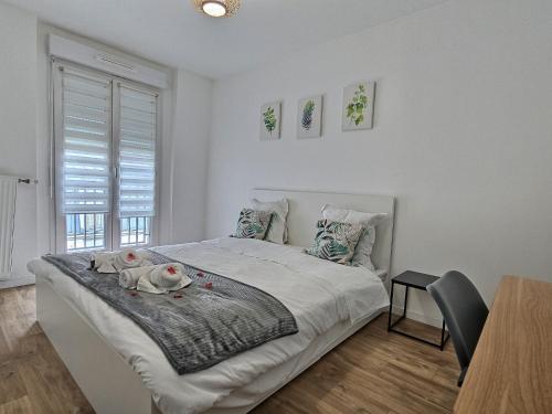 a bedroom with a bed with a dog laying on it at Paris & DisneyLand - 2min From Train Station - Free Private Parking in Villiers-sur-Marne