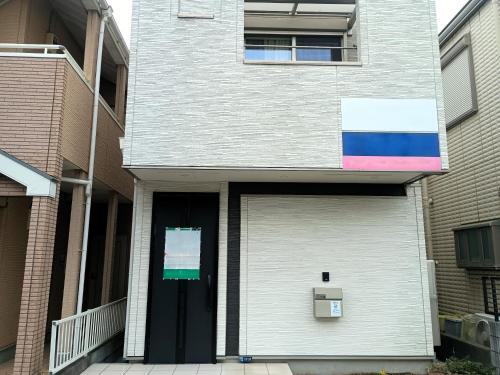 a white building with a door with a rainbow at N's room & park ,Tokyo, Guest House - Vacation STAY 18814 in Tokyo