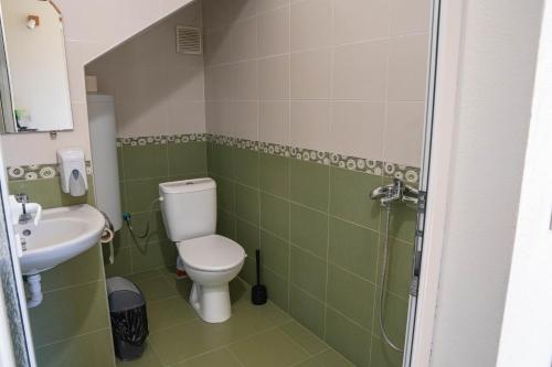 a bathroom with a toilet and a sink at Bendida Village in Pavel Banya