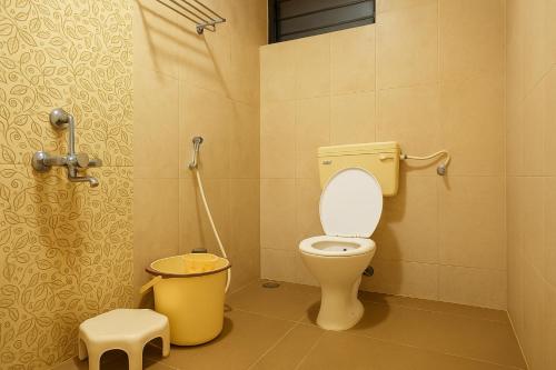 a bathroom with a toilet and a shower at The Grantley Hotel - Alibag Beach in Alibag
