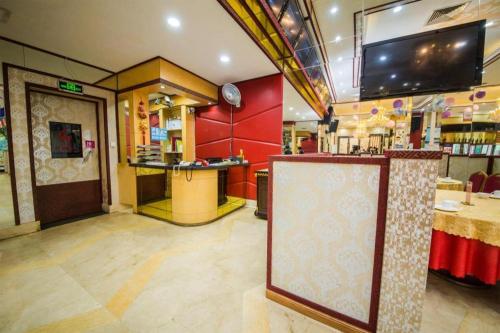 a restaurant with a bar and a sign in a room at Milu Hotel in Guangzhou