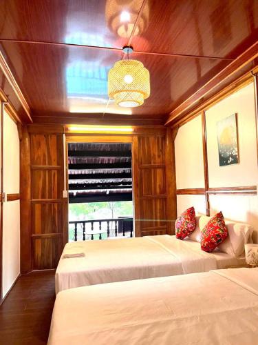 a bedroom with two beds in a boat at Woodstock Beach Camp in Cat Ba