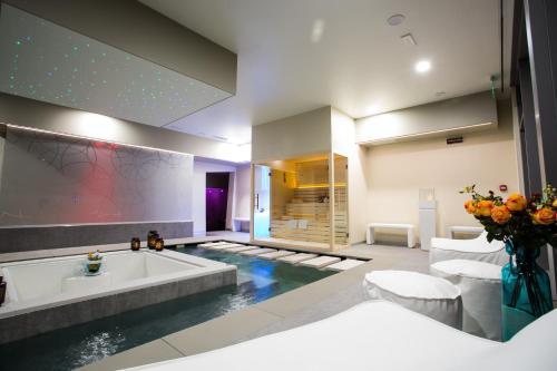 a bathroom with a bath tub and a sink at Hotel Abano Astoria in Abano Terme